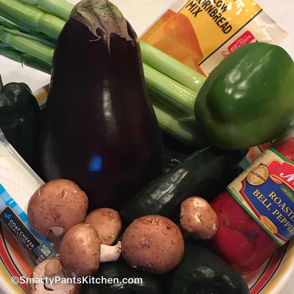 Eggplant, potatoes, celery and green bell pepper in a bowl