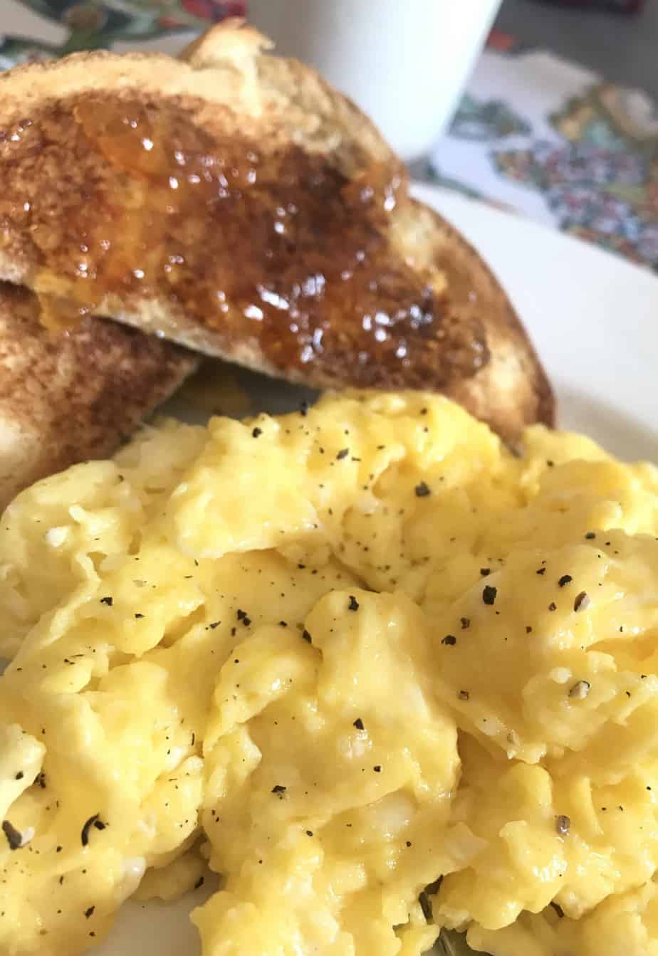scrambled eggs and toast on plate