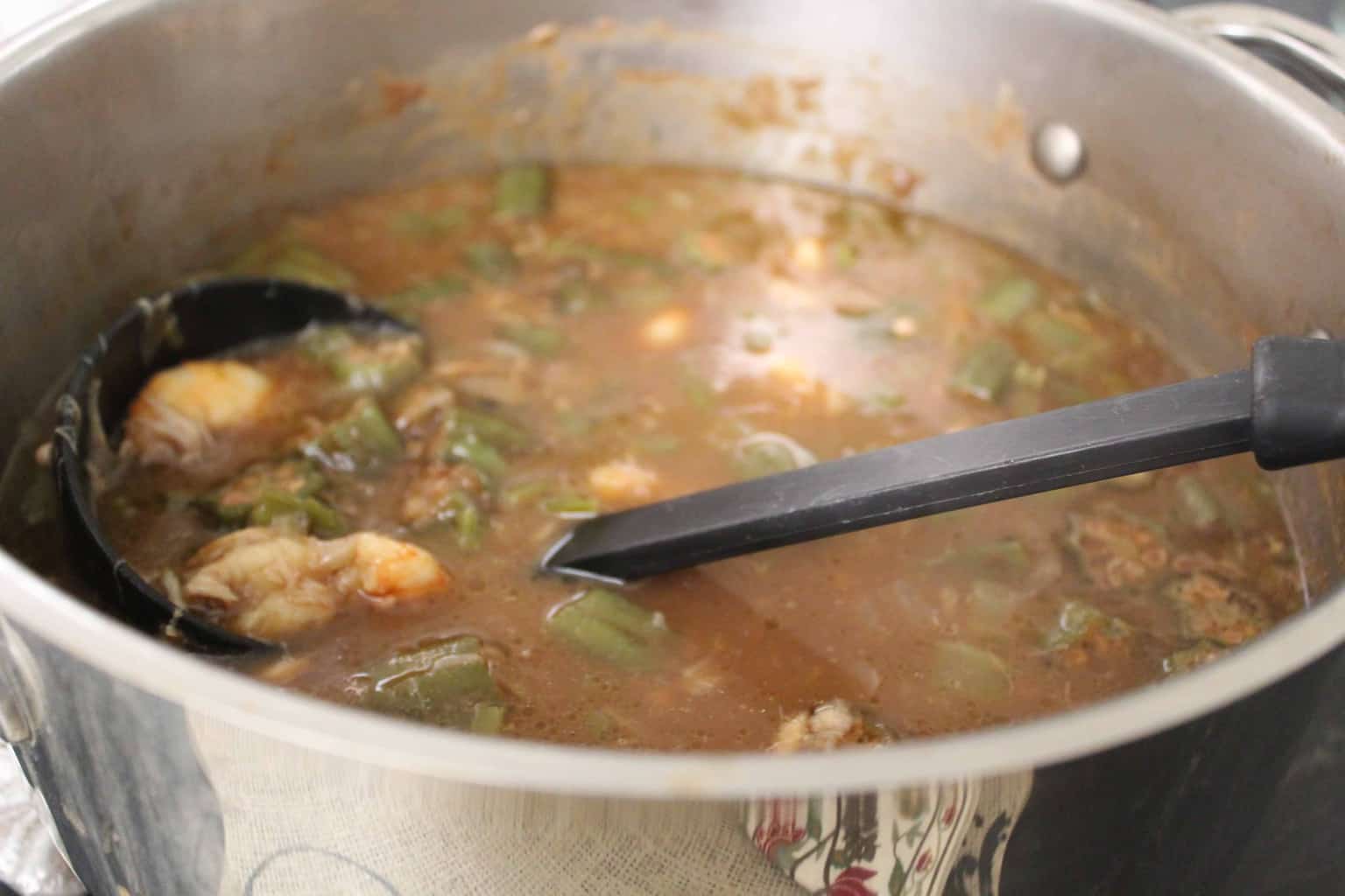 Seafood gumbo in large stockpot on stove.