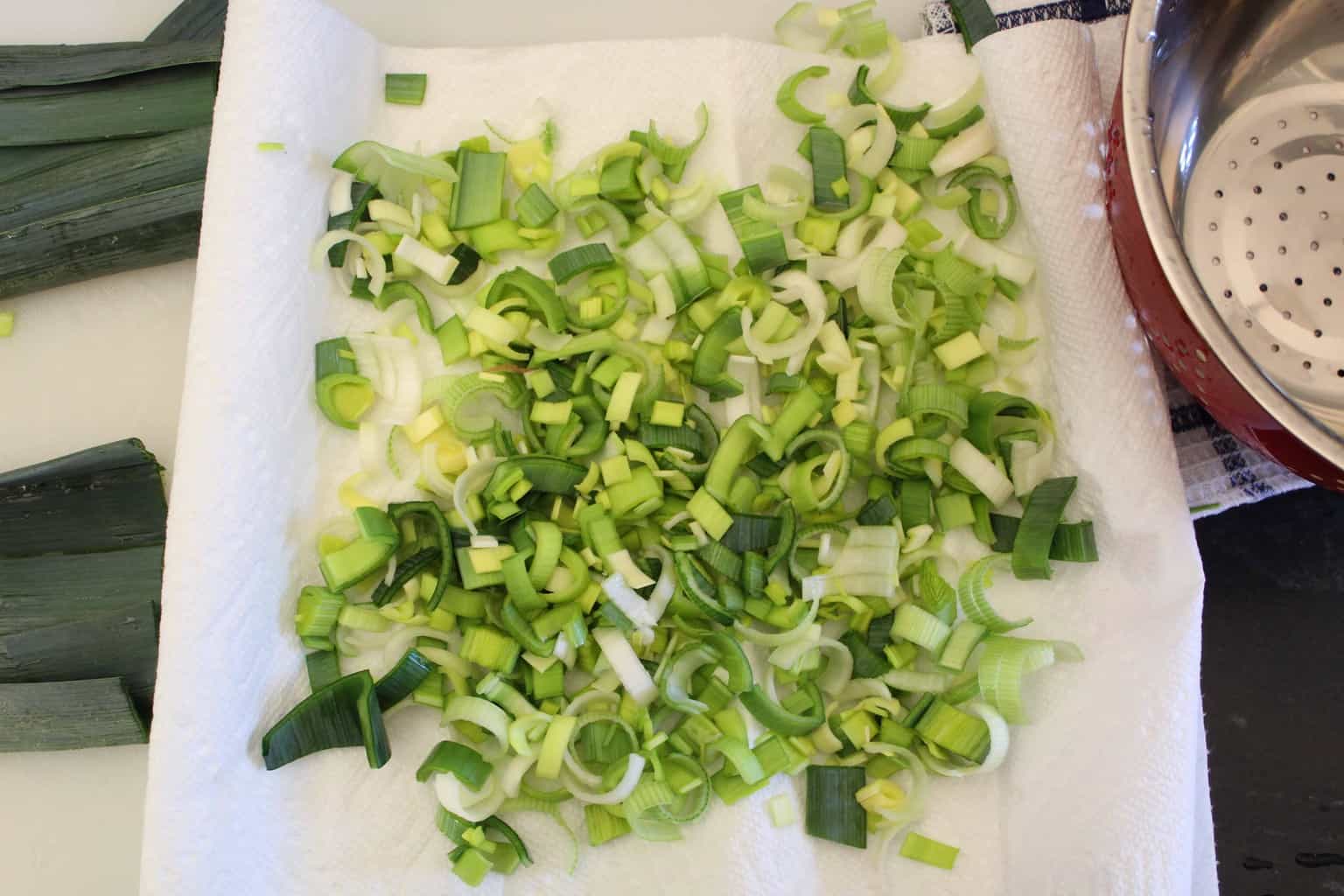 Sliced leeks on cutting board.