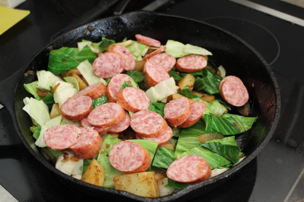 Cabbage, sausage and potatoes in cast iron skillet