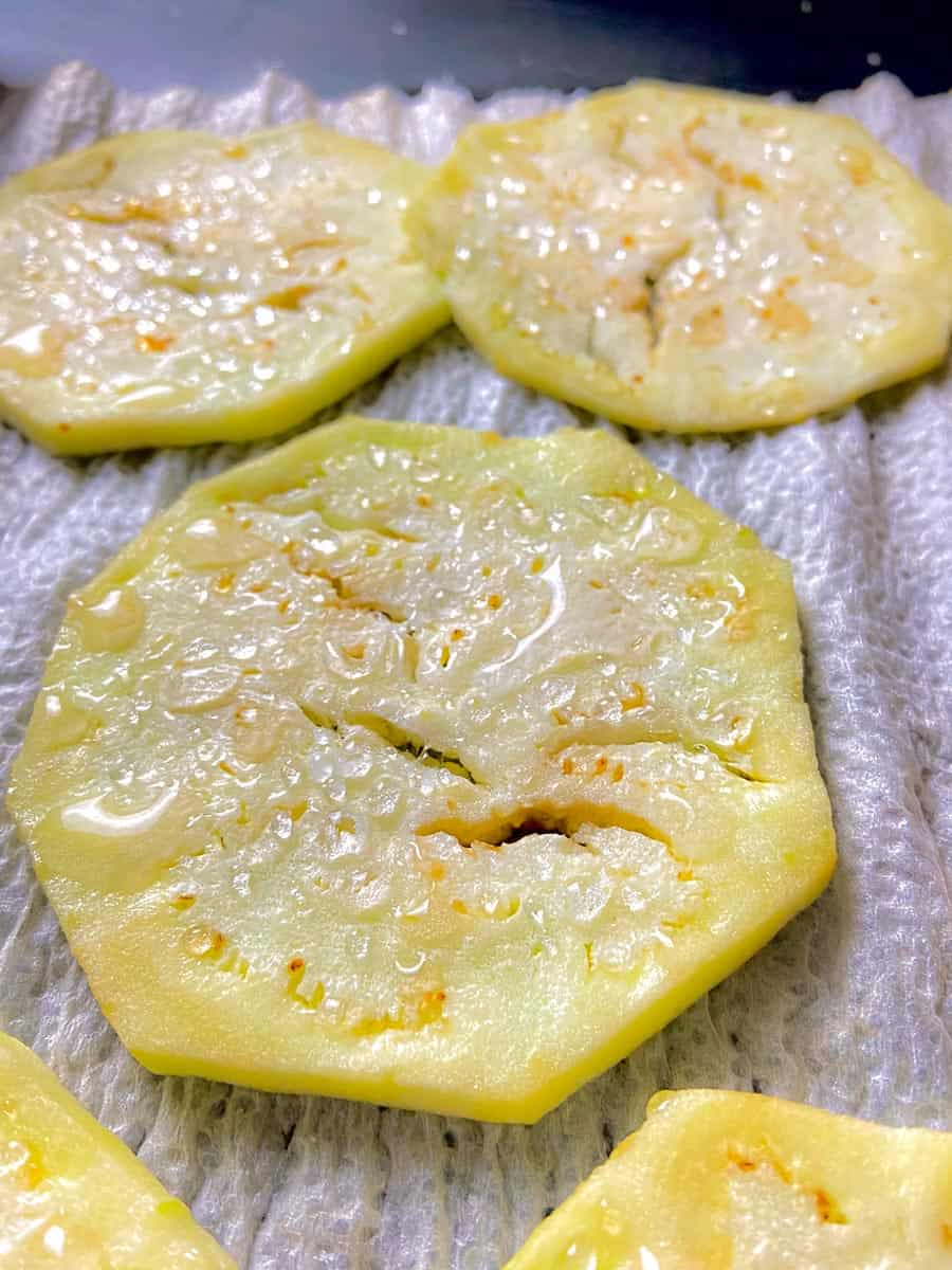 Salted eggplant round on paper towel 