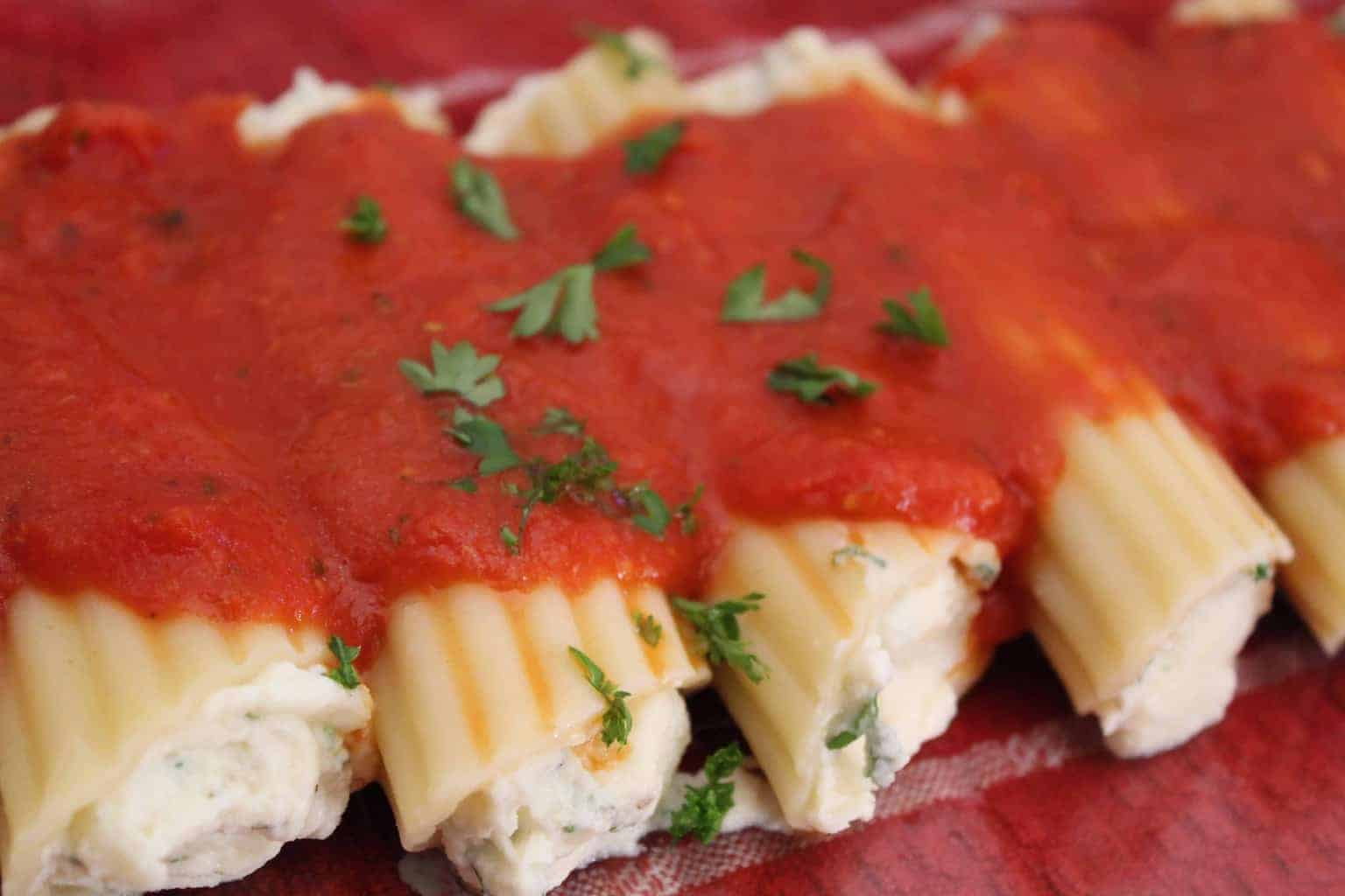 Manicotti shells stuffed with savory ricotta and mozzarella cheeses, topped with San Marzano pasta sauce