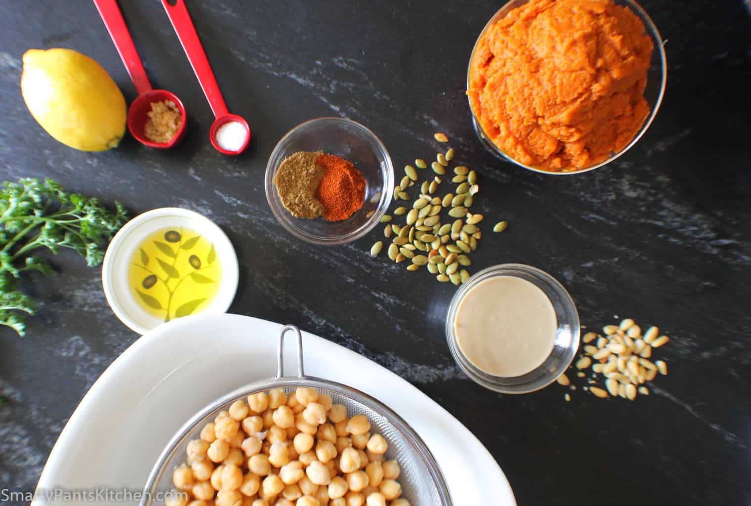 Ingredients for hummus on black marble counter