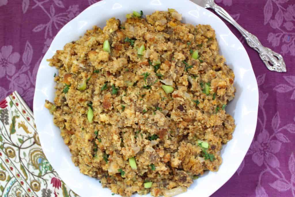 Cornbread dressing in scalloped bowl.