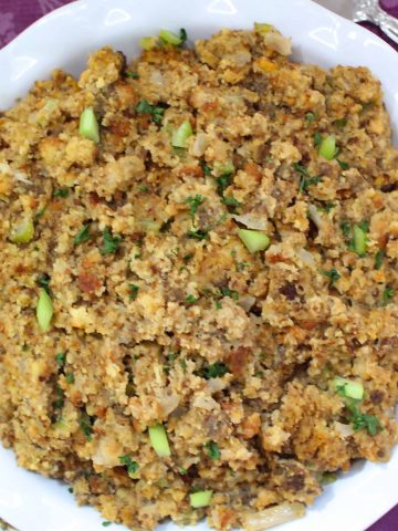 Cornbread dressing in scalloped bowl.