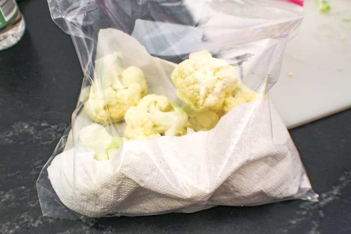 Plastic bag with florests and a paper towel in it.