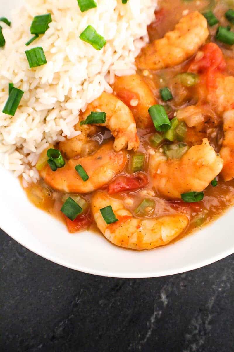 Louisiana Shrimp Etoufee in white bowl with side of rice.