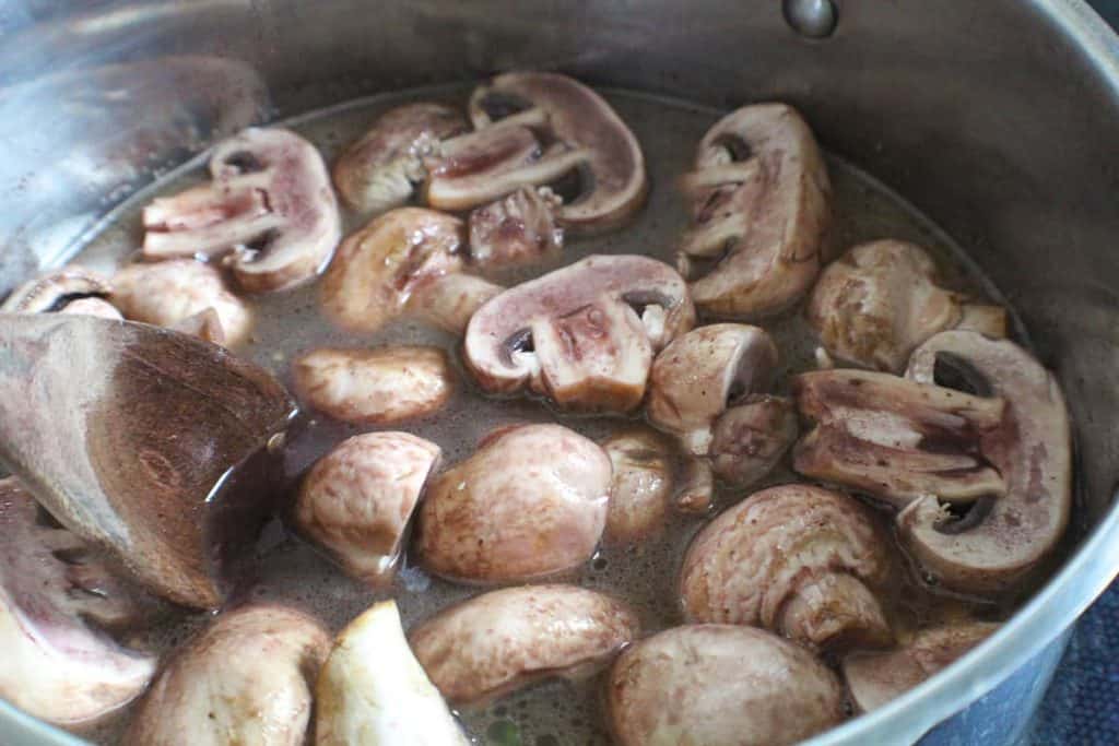 Burgundy Mushrooms marinating in wine on stove