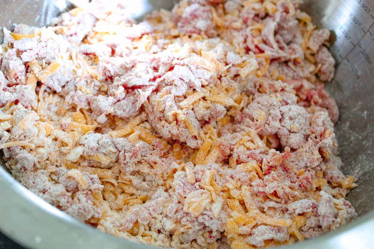 Cheese and sausage mixture in mixing bowl.