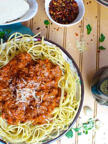 Bolognese sauce spooned over spaghetti