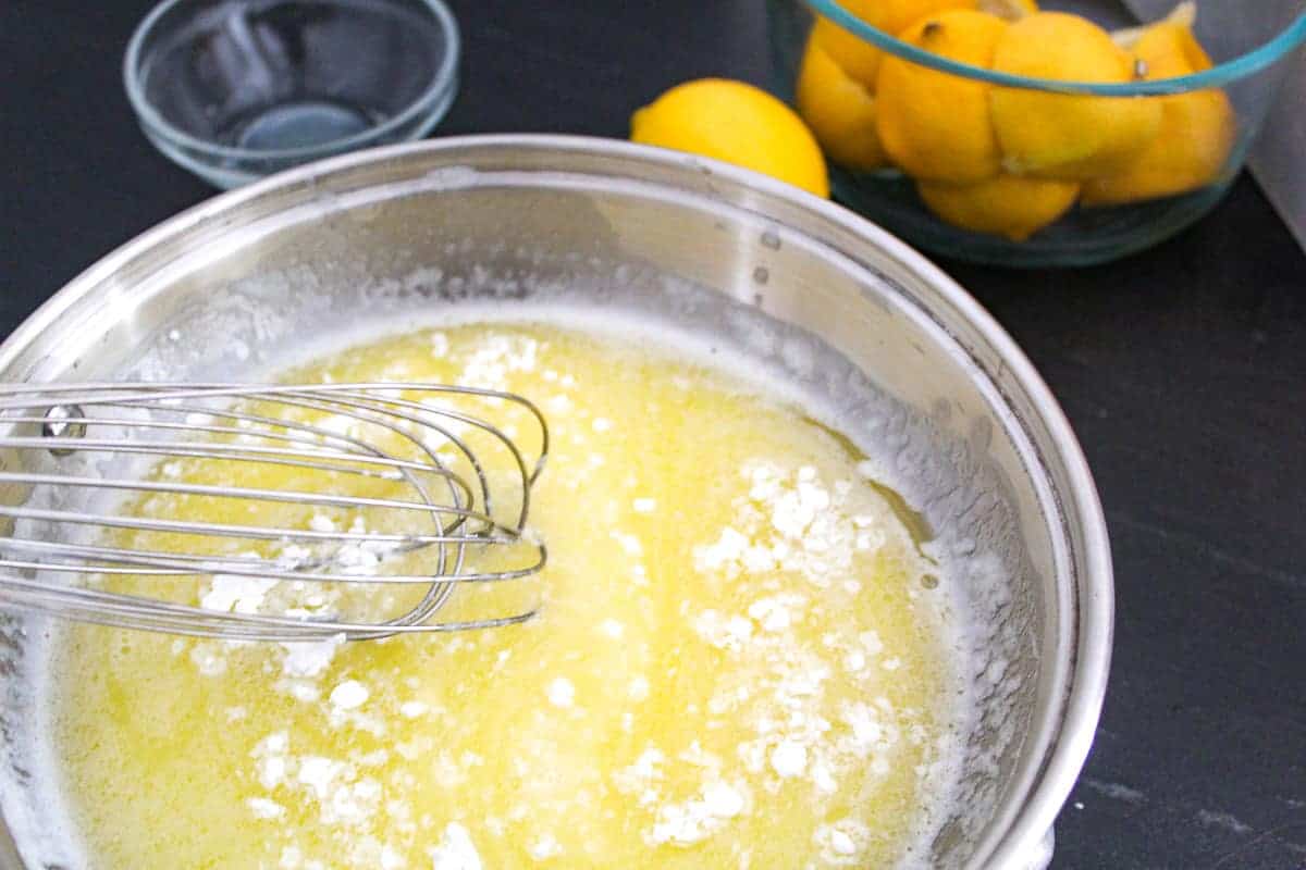 Cornstarch being whisked into melted butter in saucepan