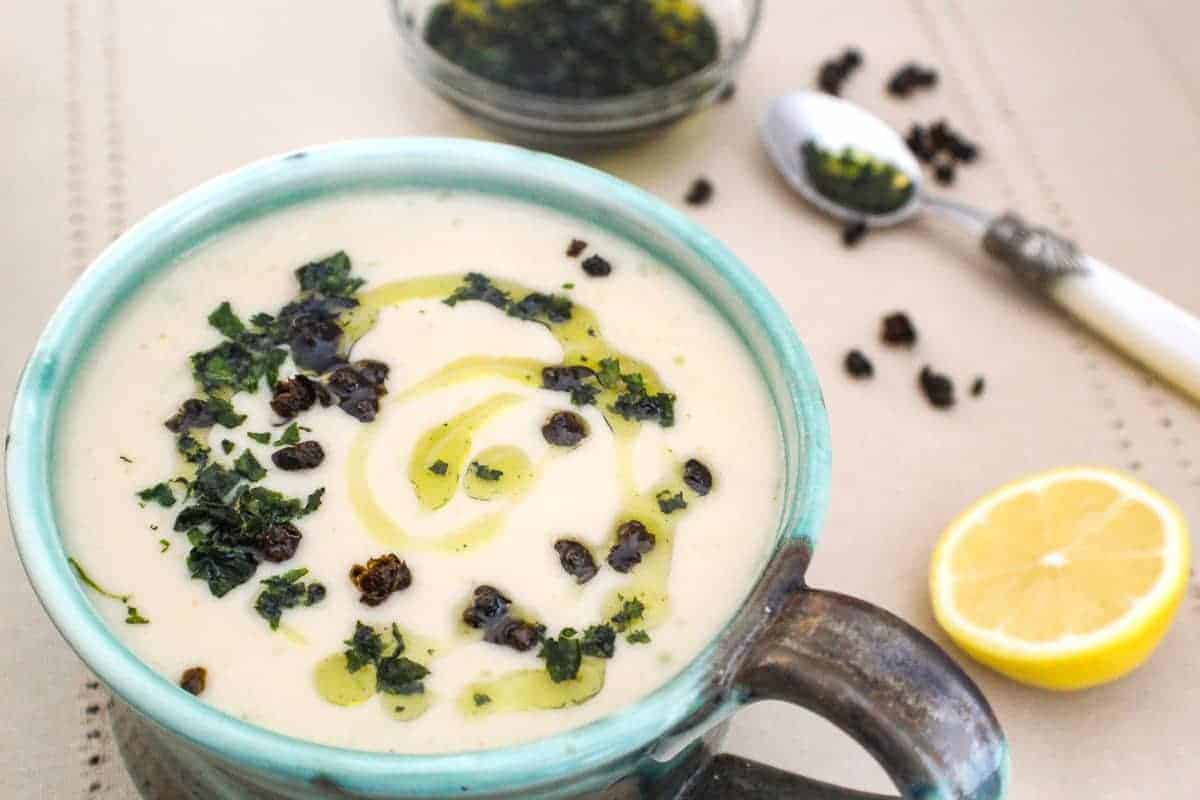 Creamy White Bean Soup in a green bowl drizzled with olive oil.