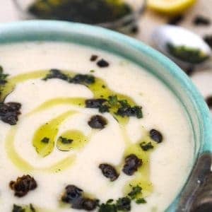 Creamy White Bean Soup drizzled with olive oil in green bowl