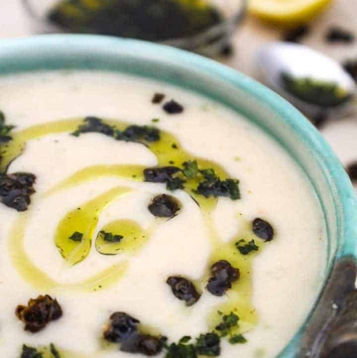 Creamy White Bean Soup drizzled with olive oil in green bowl