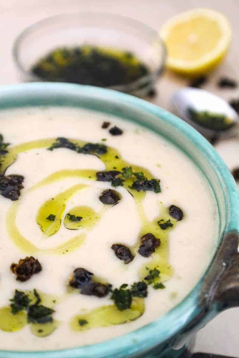 Creamy White Bean Soup drizzled with olive oil in green bowl