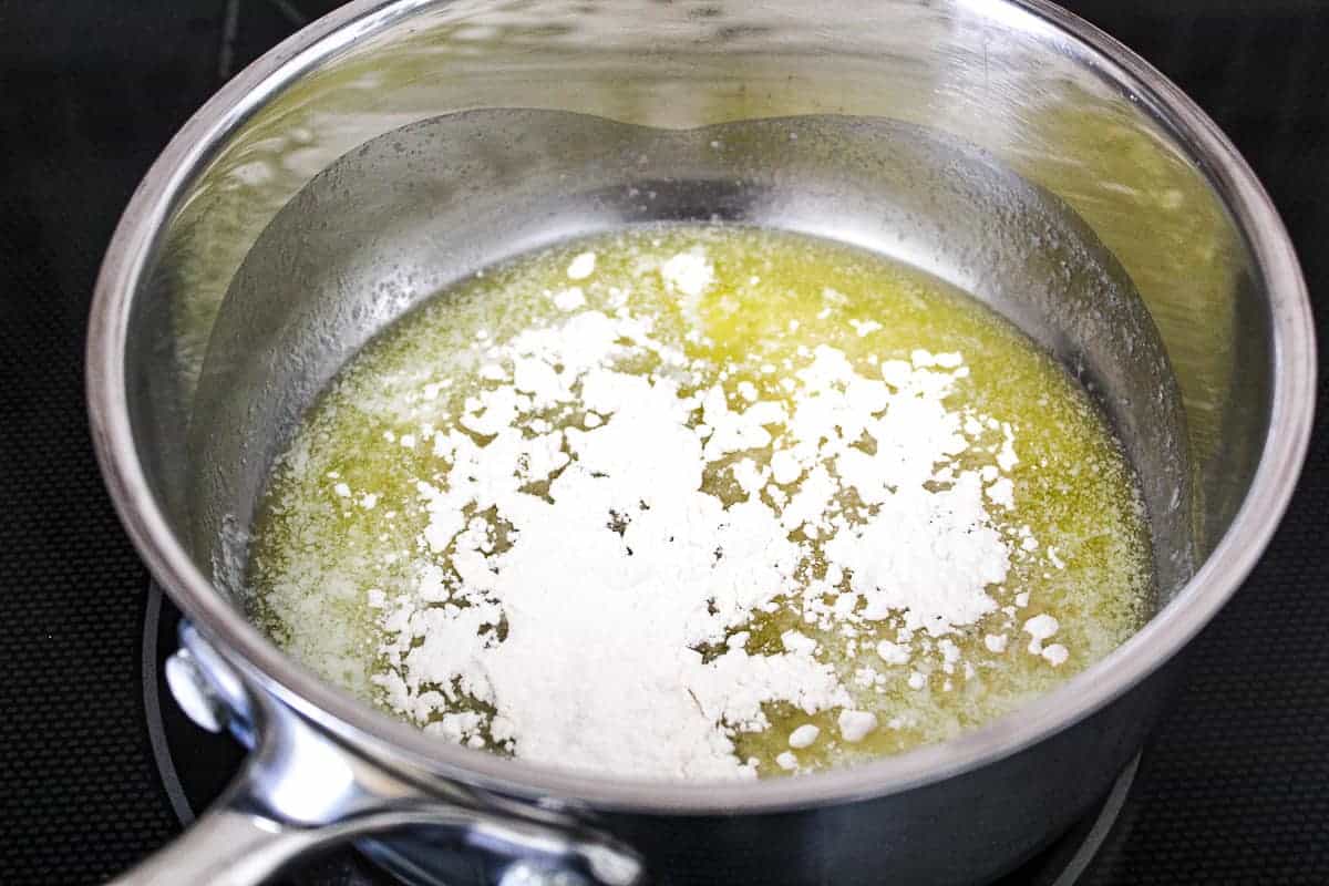 Melted butter with flour sprinkled in saucepan