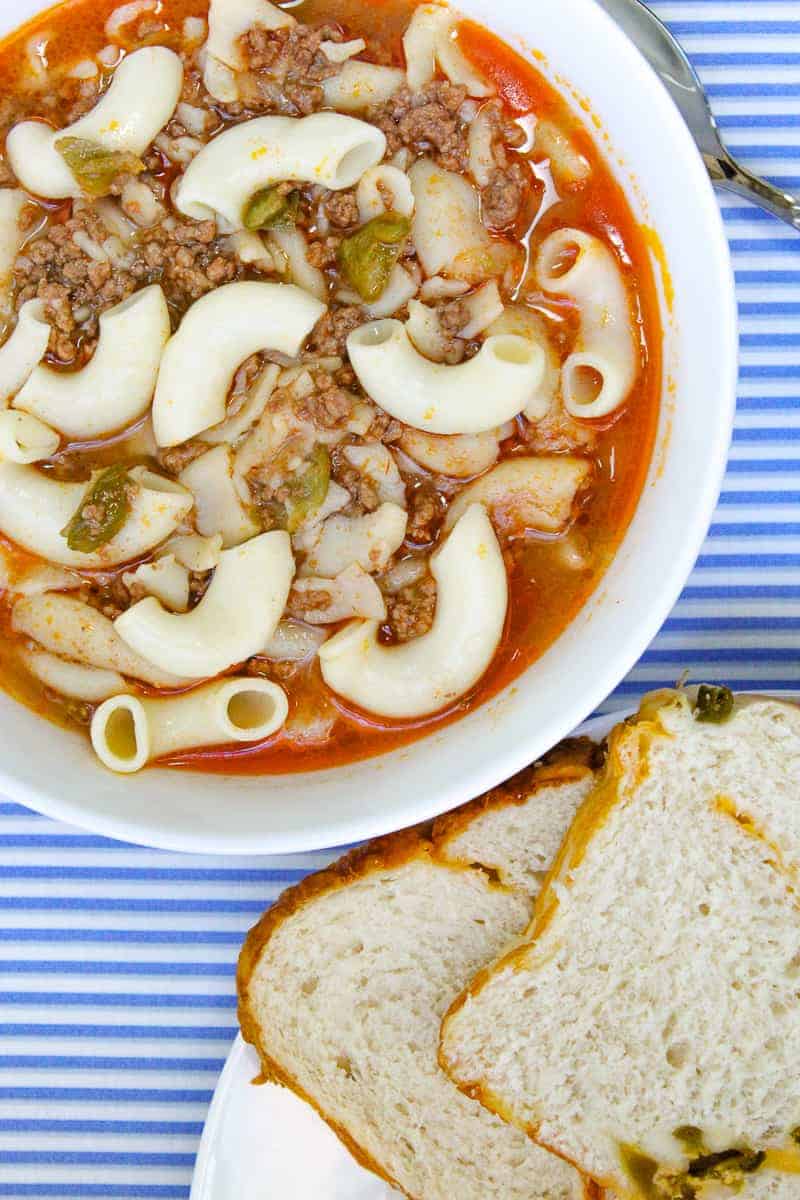 Bowl of goulash in a white bowl.