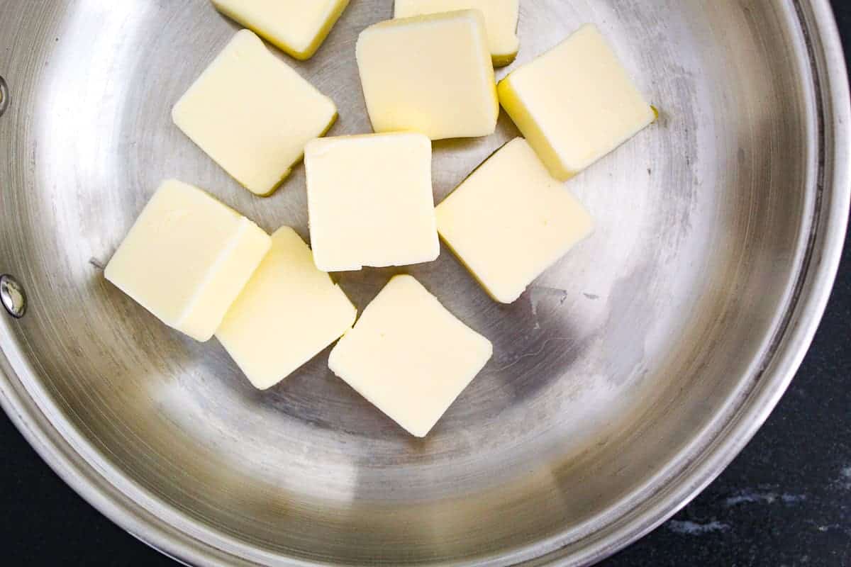 Cubed butter melting in pan