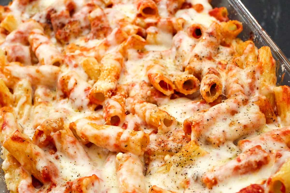 Rigatoni in baking dish with sauce and cheese