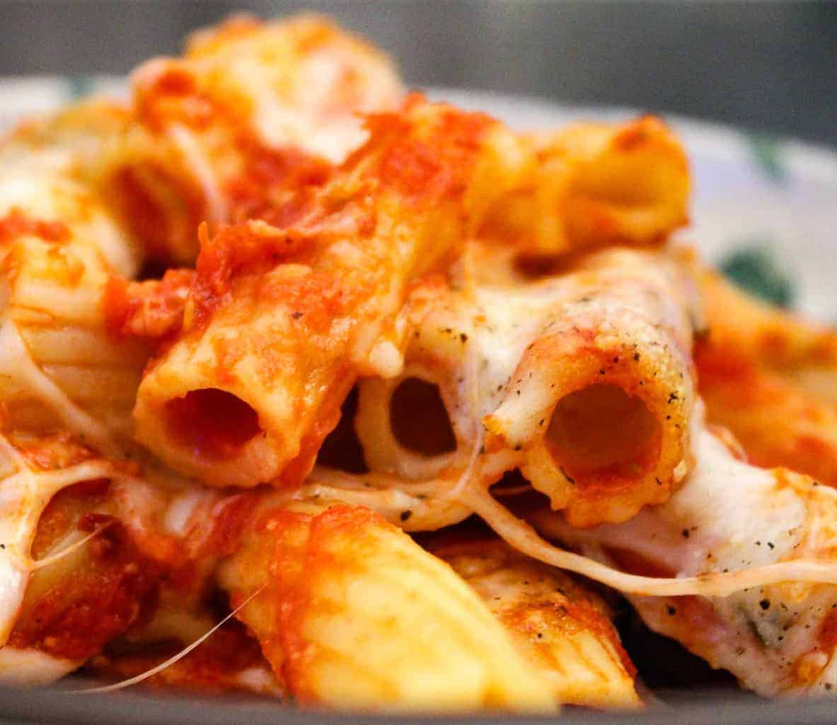 Close up of baked rigatoni with tomato sauce and cheese