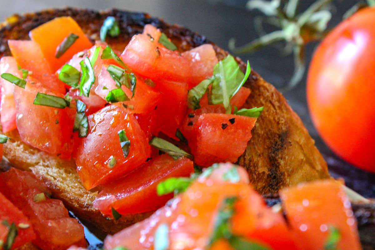 Bruschetta on toast with basil garnish