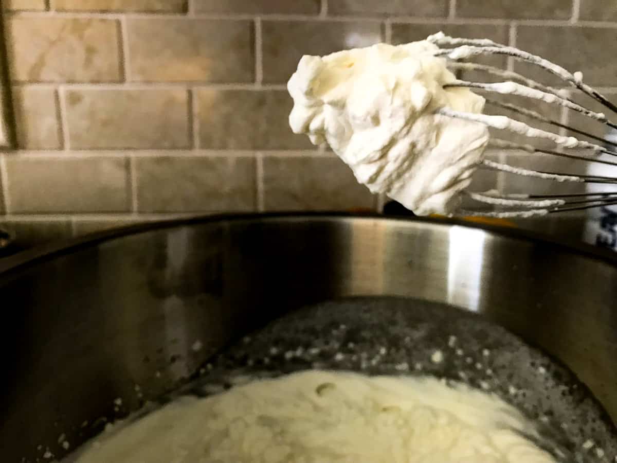 Whipped cream on a metal whisk 