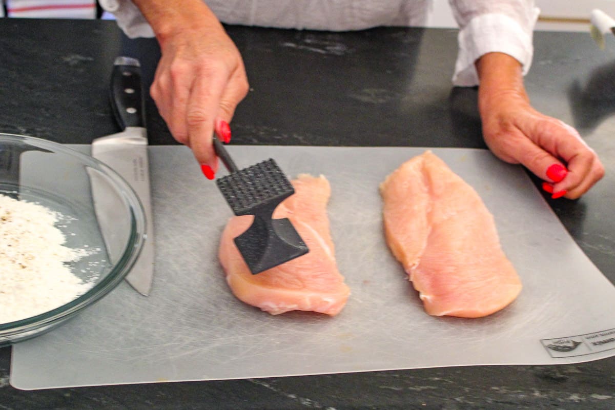 Meat cleaver pounding chicken breast