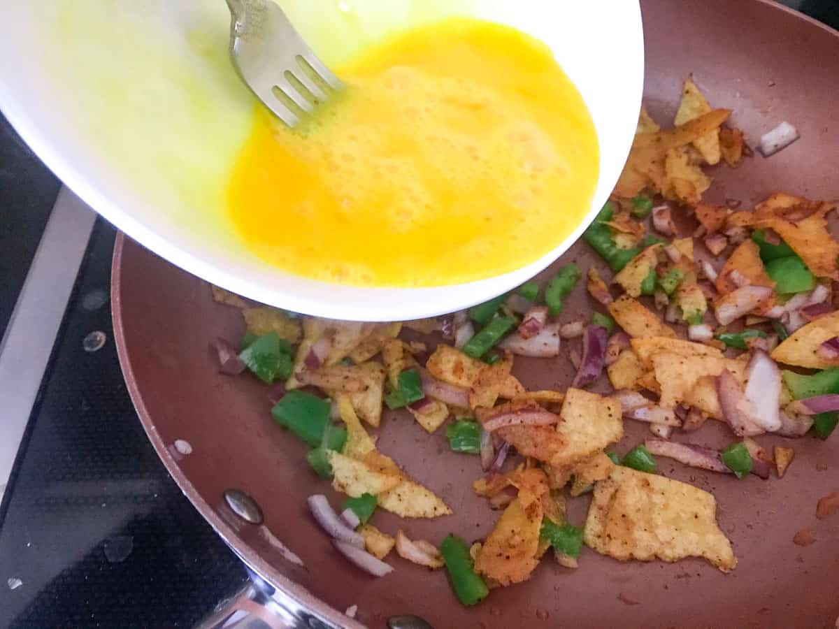 Eggs being poured into skillet.