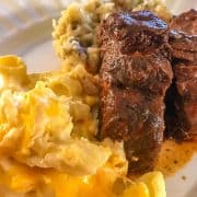Country ribs and macaroni and cheese on white plate