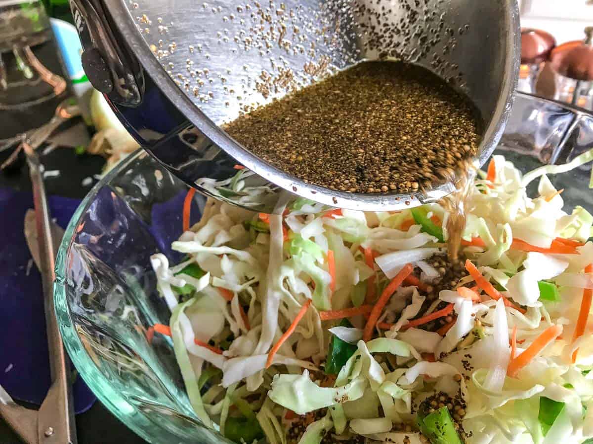 Dressing poured into coleslaw