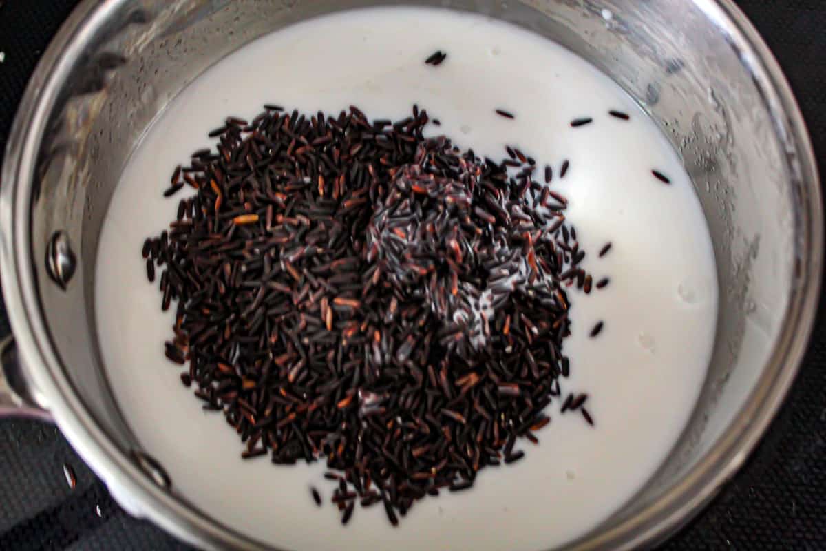 Black rice and coconut milk in saucepan