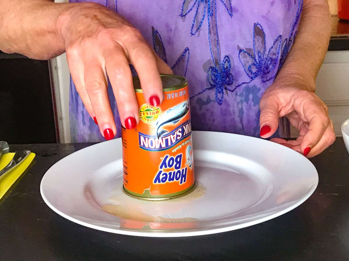 Canned salmon draining on plate