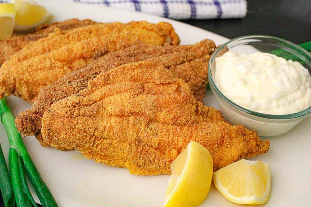 Fried catfish filets with tartar sauce.