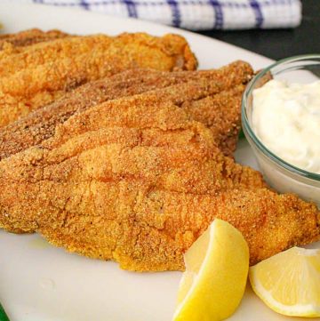 Fried catfish filets with tartar sauce.