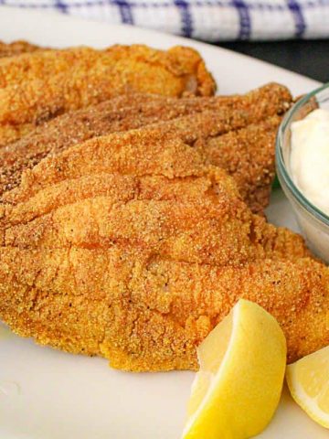 Fried catfish filets with tartar sauce.