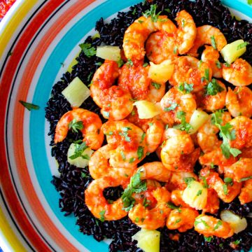 Harissa shrimp and black rice in colorful bowl