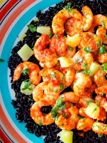 Harissa shrimp and black rice in colorful bowl