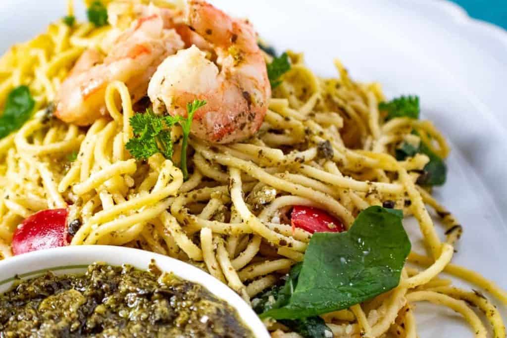Close up of shrimp and pasta with pesto