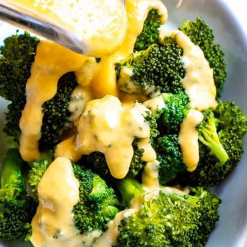 Cheddar cheese sauce drizzled over broccoli