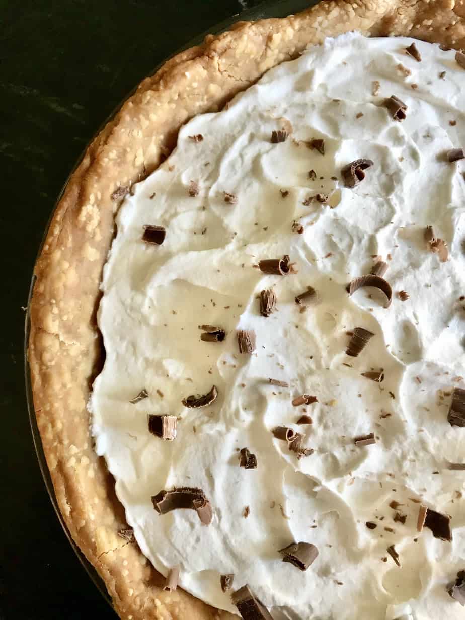 Old Fashioned Chocolate Pie topped with whipped cream and chocolate shavings