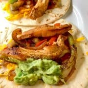 Tex Mex fajitas open faced on a white plate