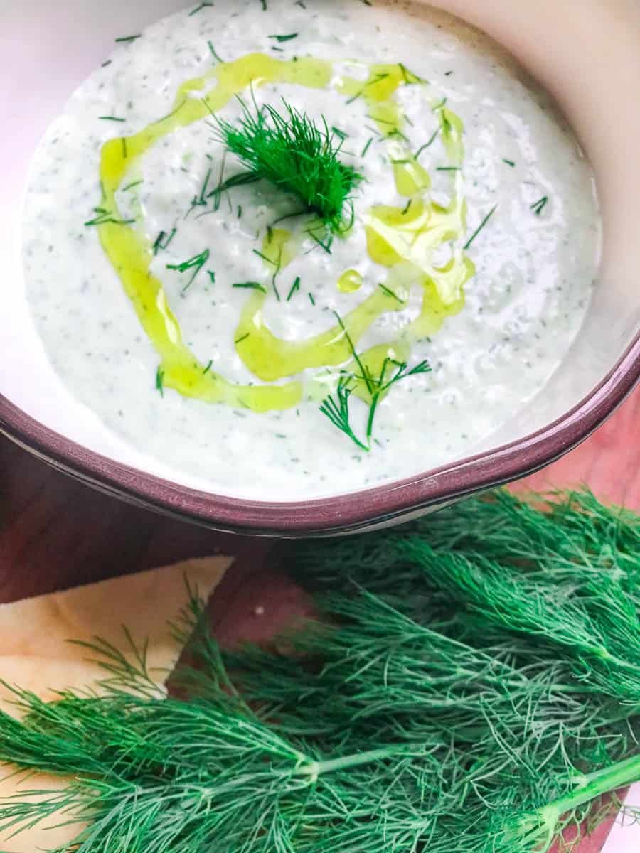 Greek Yogurt Sauce in bowl garnished with fresh dill and olive oil