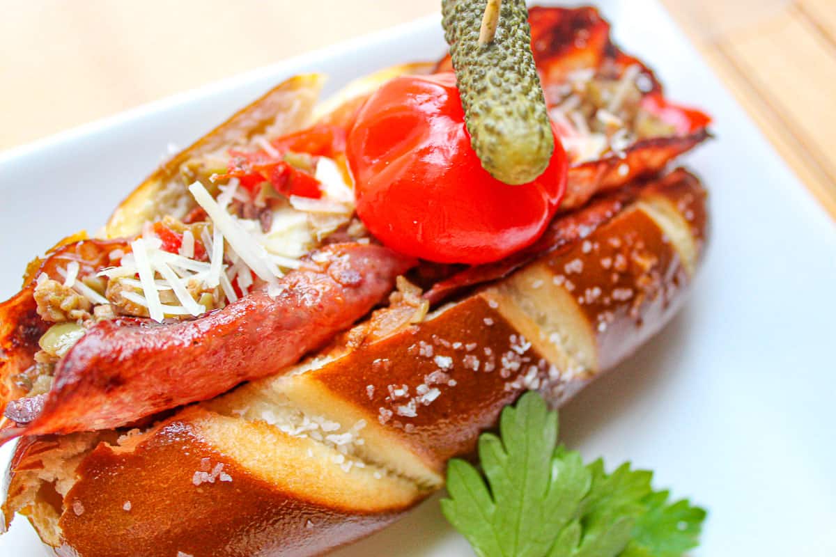 Italian hot dog in pretzel bun with salami 