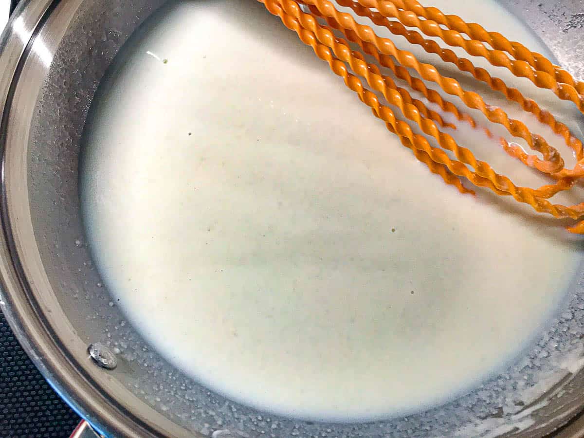 milk and roux in saucepan