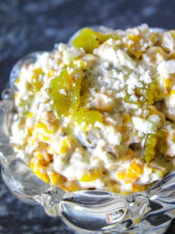 Roasted corn and green chile dip in glass bowl