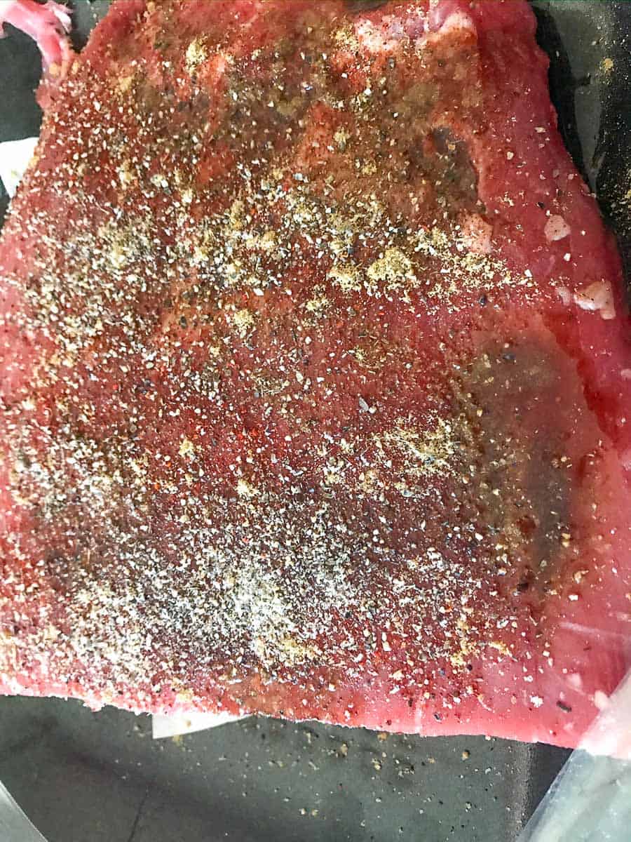 Flank steak seasoned with dry spices.