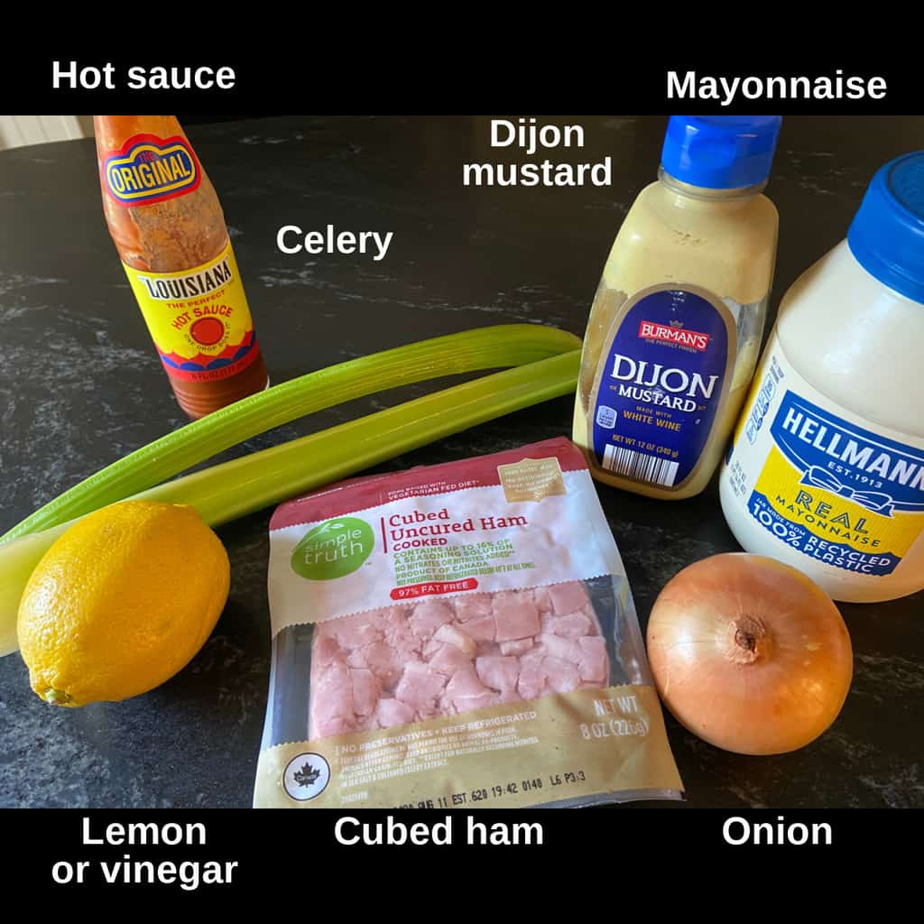 Ingredients for deviled ham dip spread labeled on countertop.