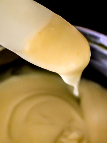 Condensed soup on spatula over saucepan