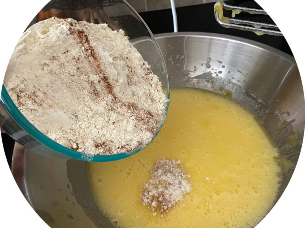 Dry ingredients being added to sugar mixture